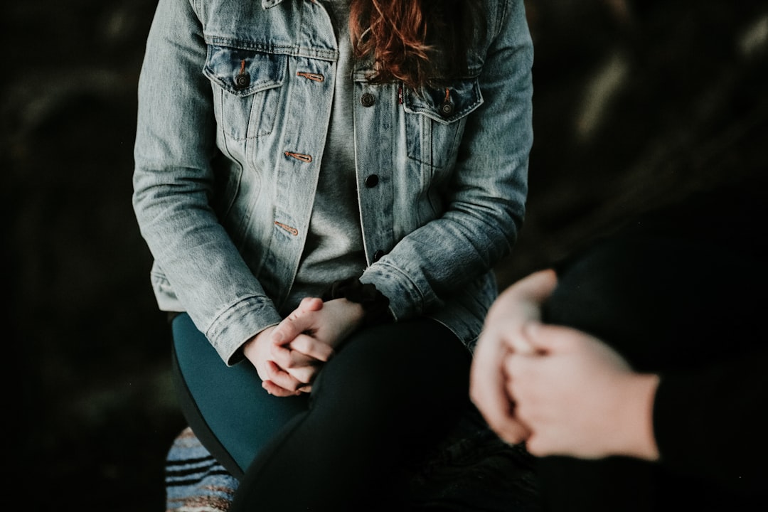 woman in denim jacket sitting
